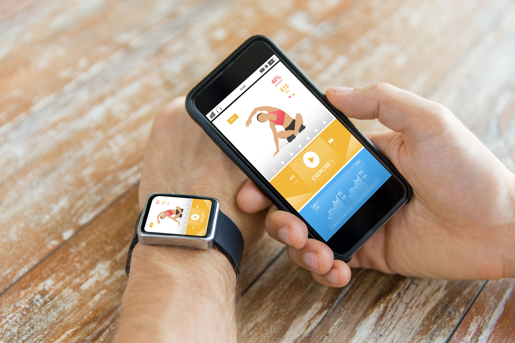 60347015 - sport, fitness, technology, responsive design and people concept - close up of male hand holding smart phone and wearing watch with sports application on screen